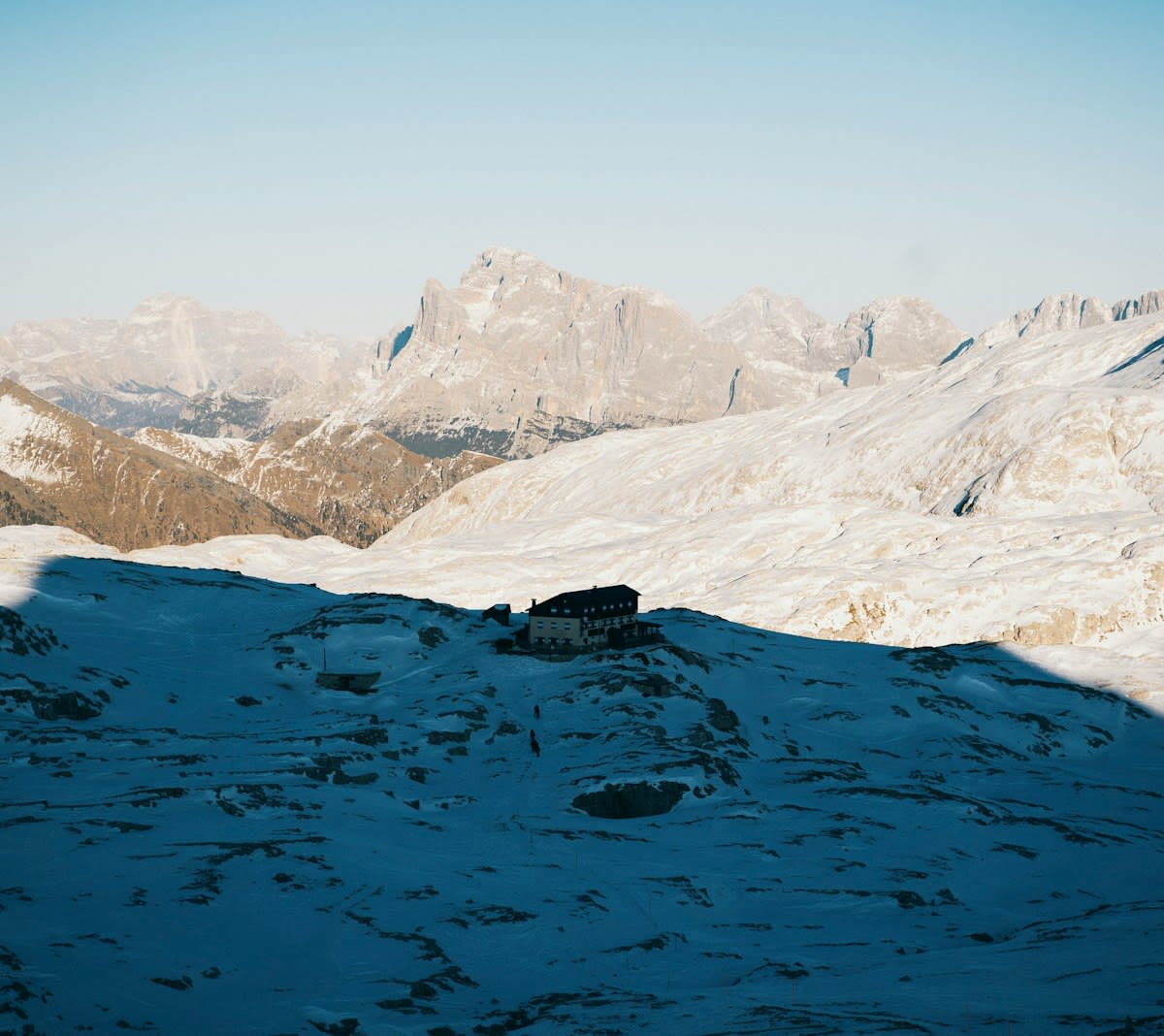 Remote mountain landscape with a single minimalist cabin