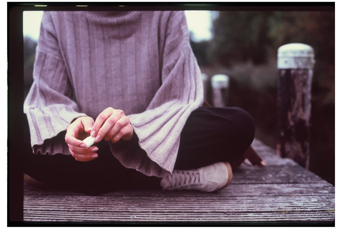 Person meditating in a peaceful outdoor setting