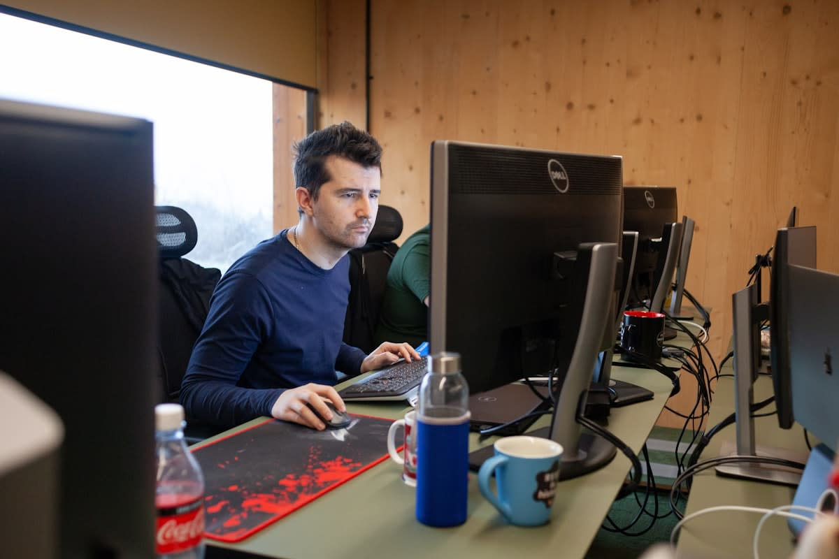 A person working on multiple monitors with data and design tools