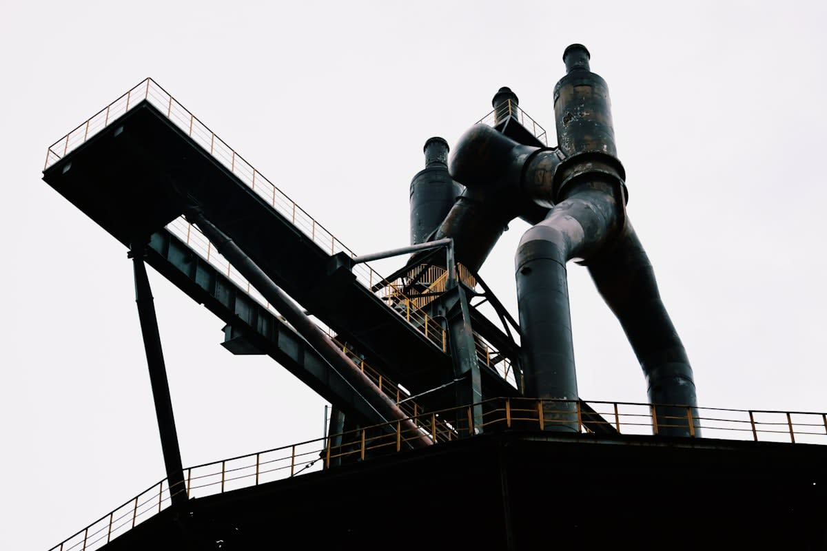 Steel mill workers analyzing pipes
