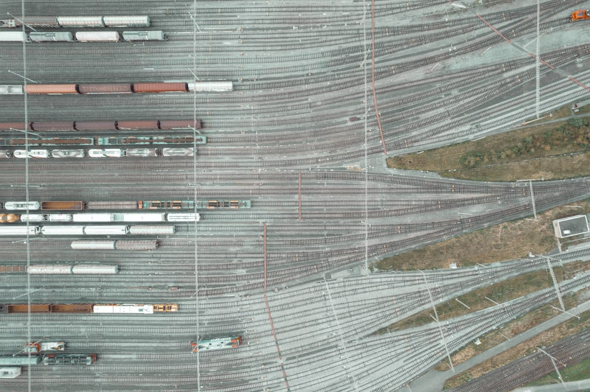 Aerial view of a massive inland container terminal with cranes and trains