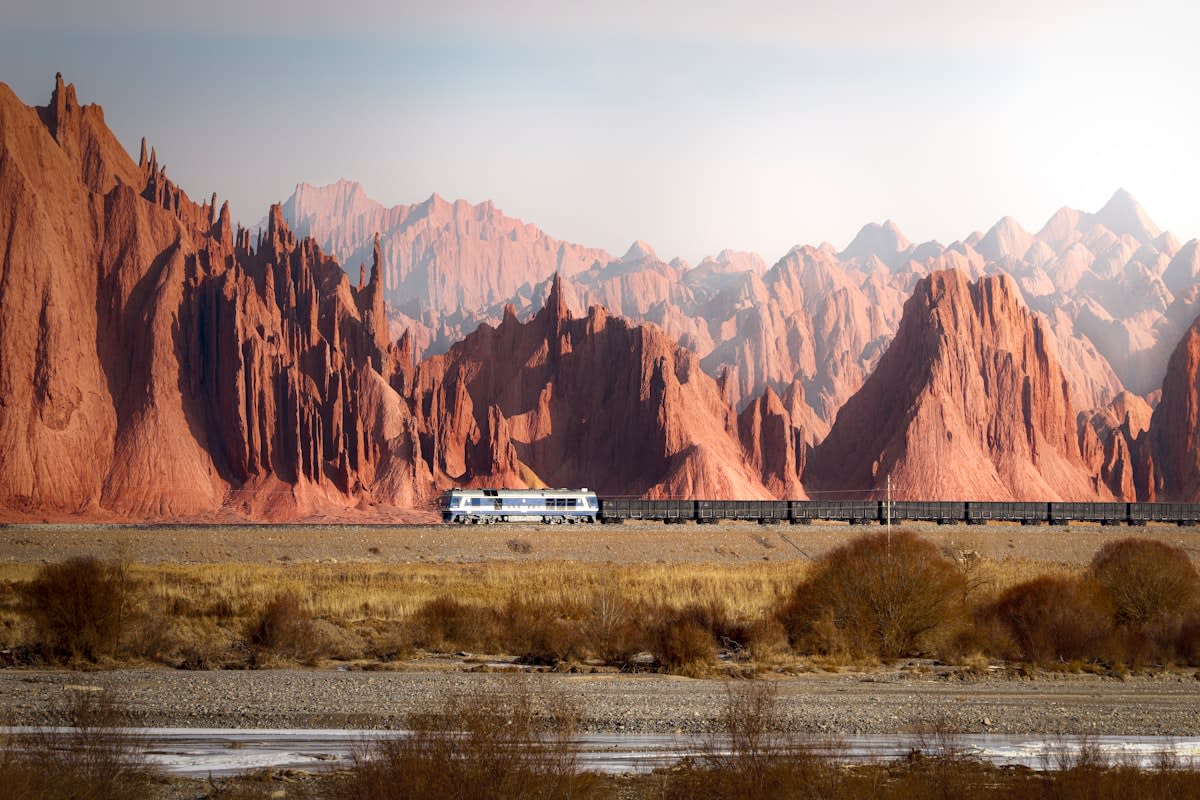Cargo trains moving through a vast landscape