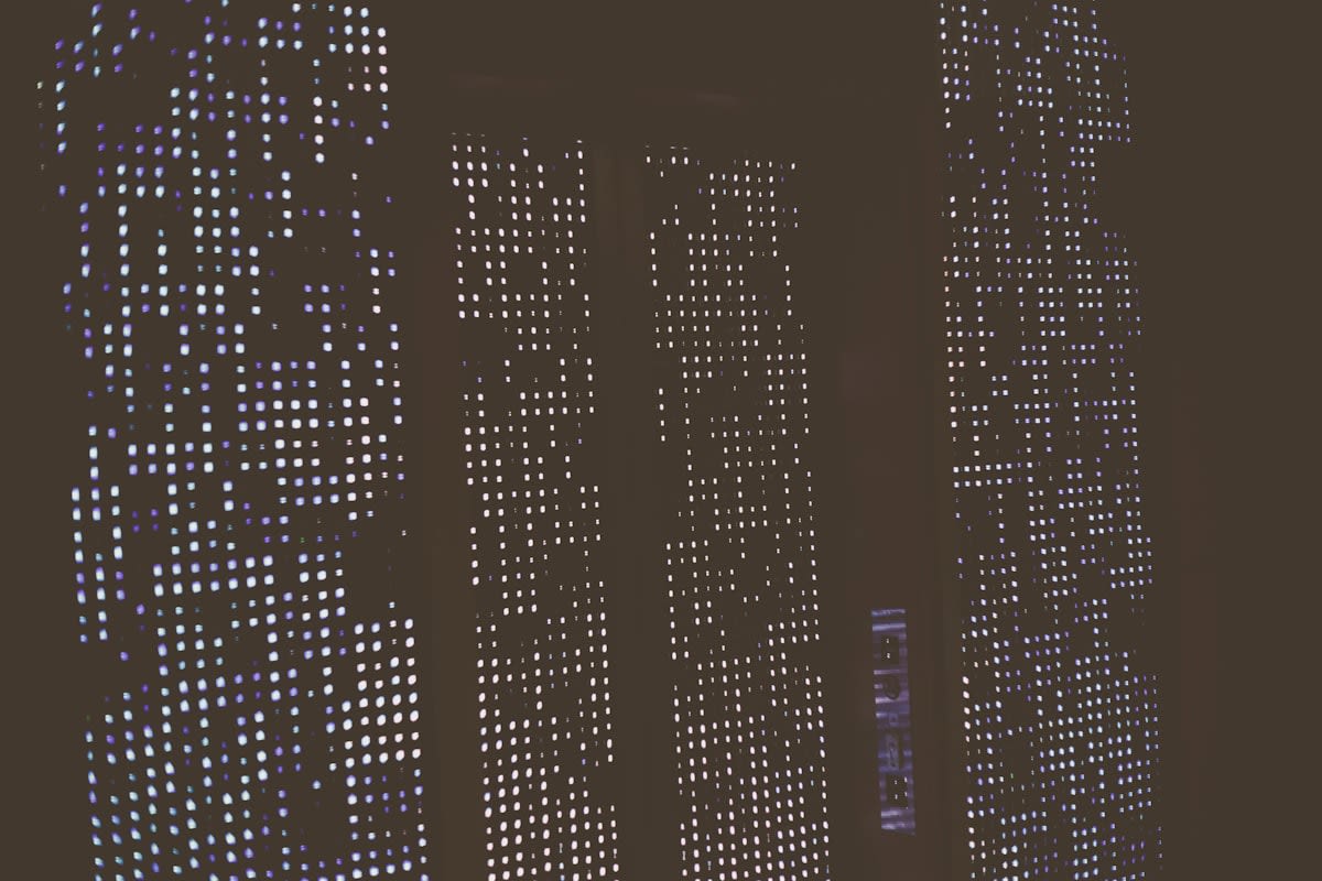 Modern skyscraper reflecting digital data patterns