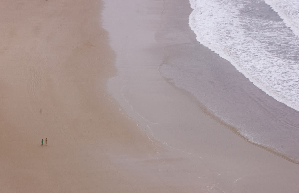 Person walking alone on a quiet beach
