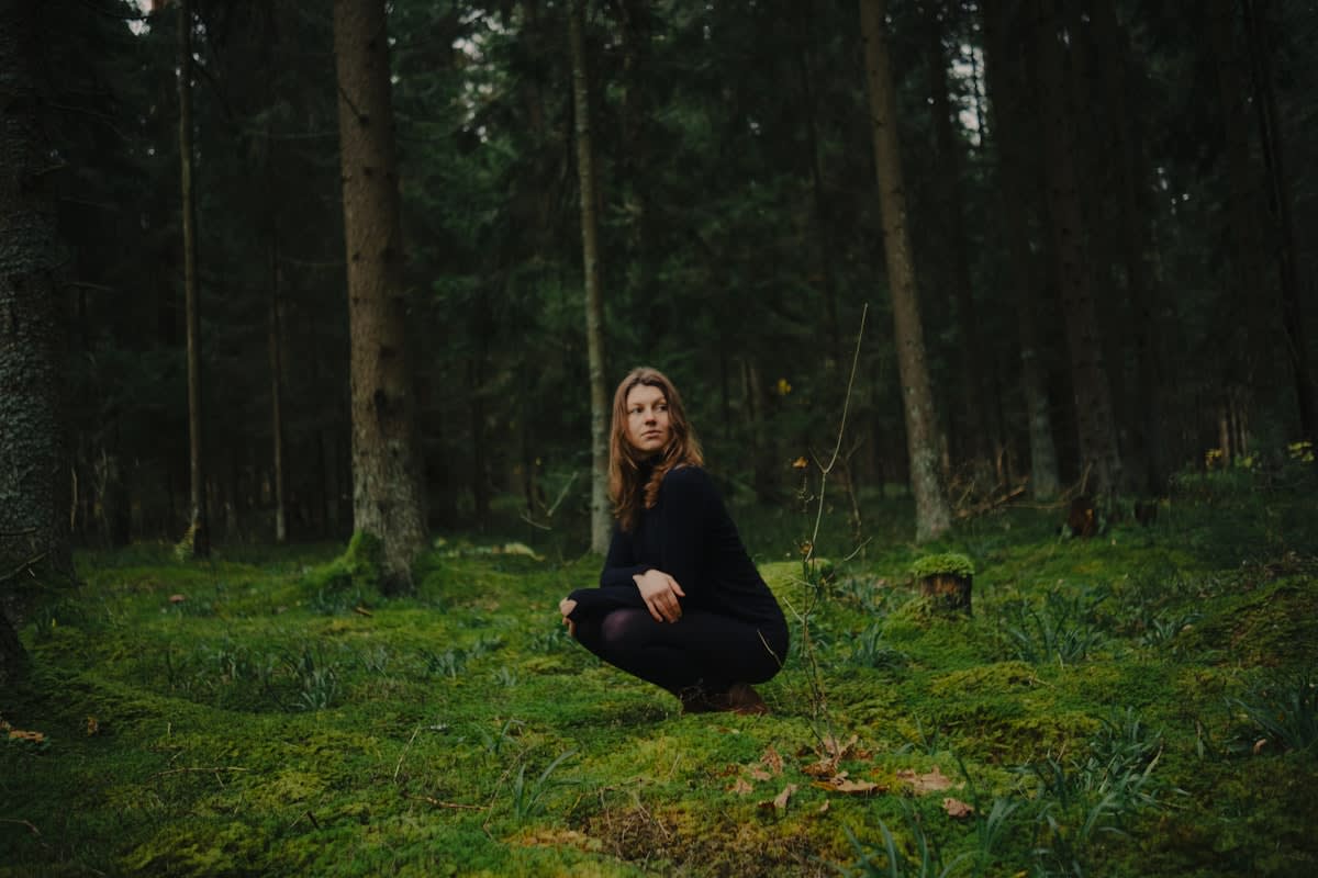 Person meditating in a serene natural environment