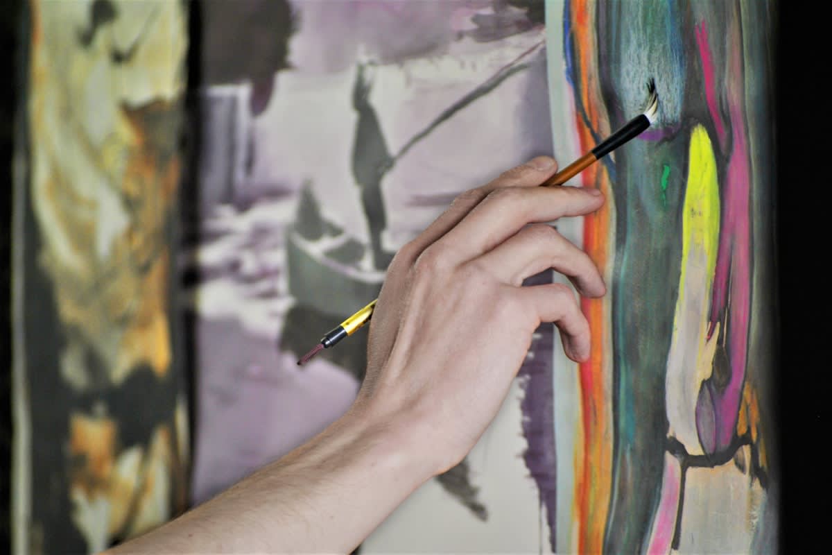 Close up of hand-painted art with visible brush strokes and paint drips