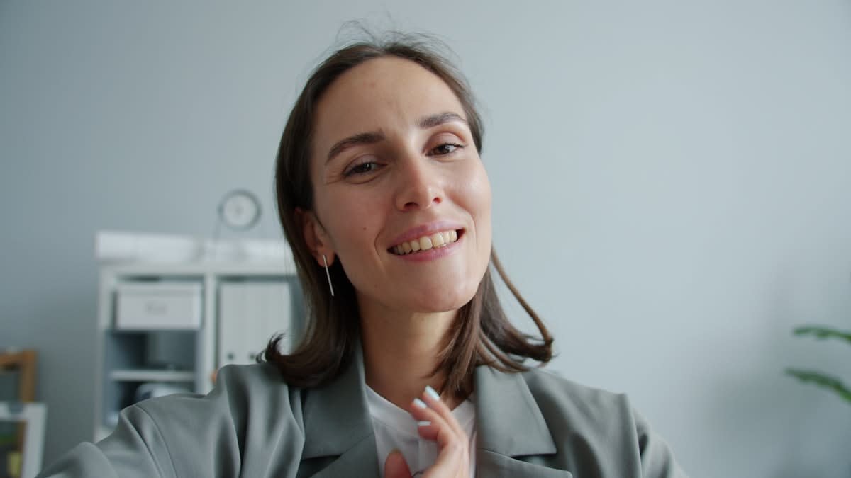 Professional woman maintaining a calm expression during a tense meeting