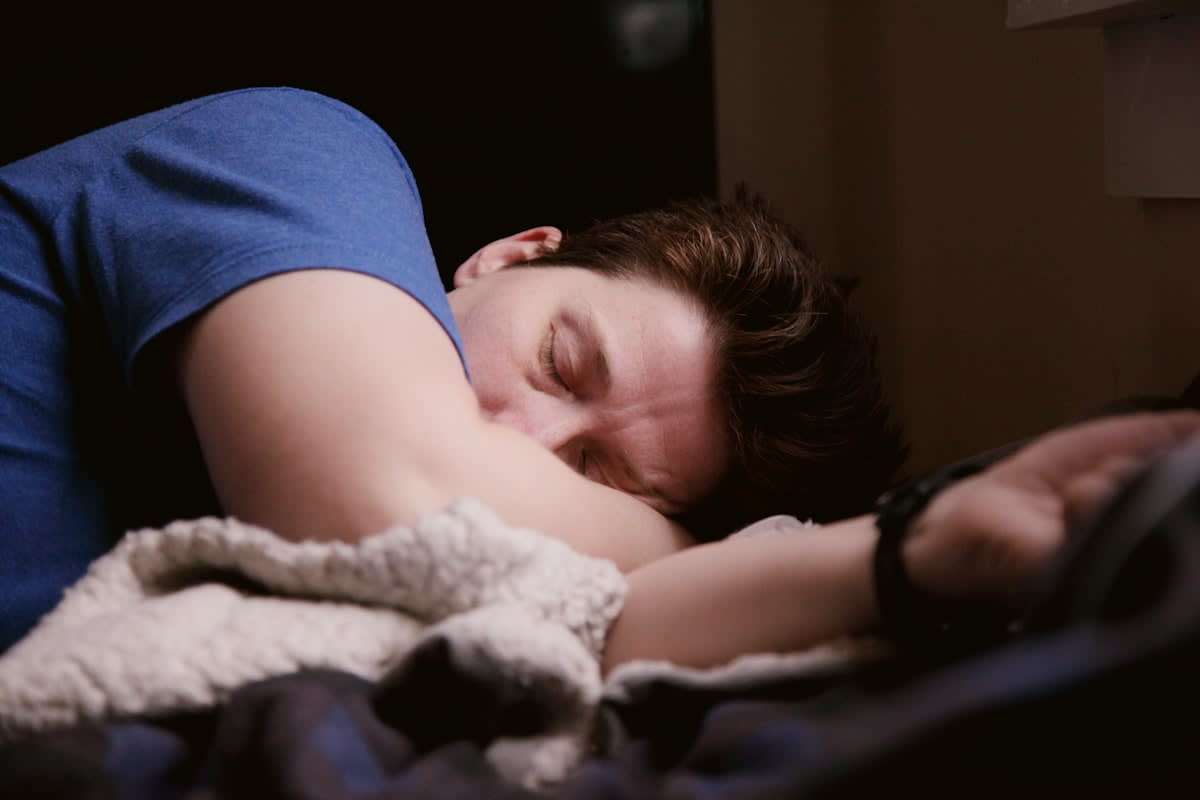 Person sleeping in a dark, cool room with blackout curtains