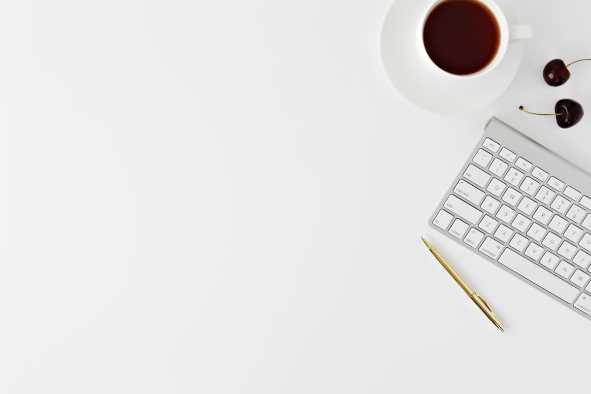 Minimalist desk with a notebook and a cup of coffee