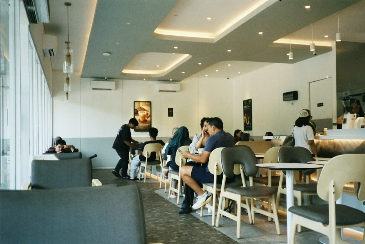 People chatting casually in a modern cafe