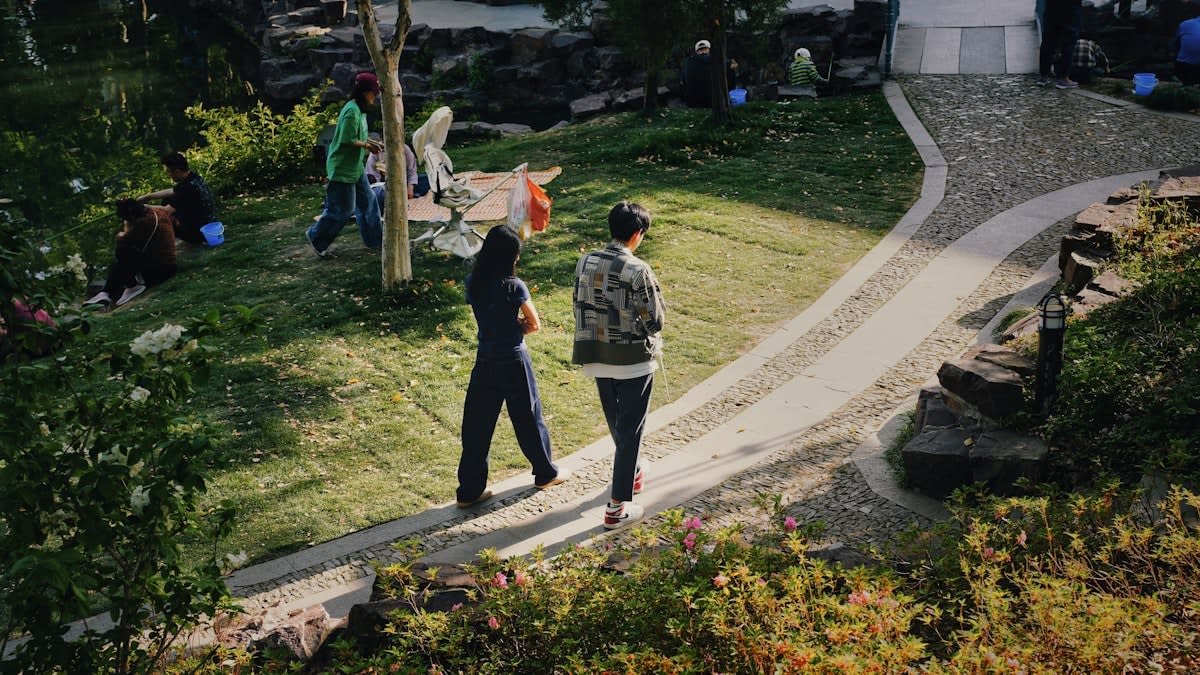 Two people walking and talking in a park
