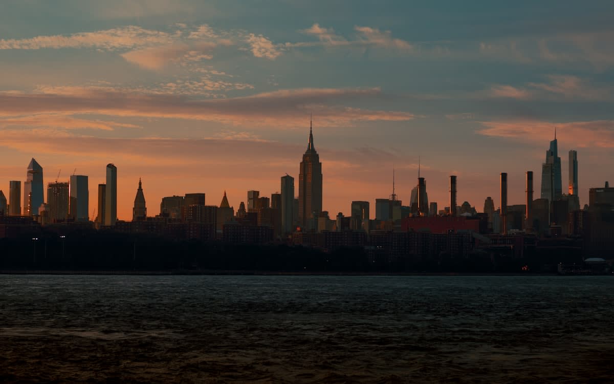 Sunrise over a city skyline representing circadian light triggers