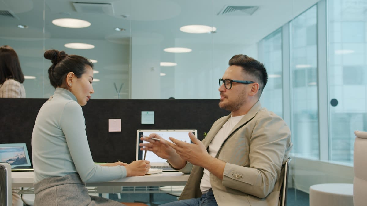 Two people in deep conversation in a modern office