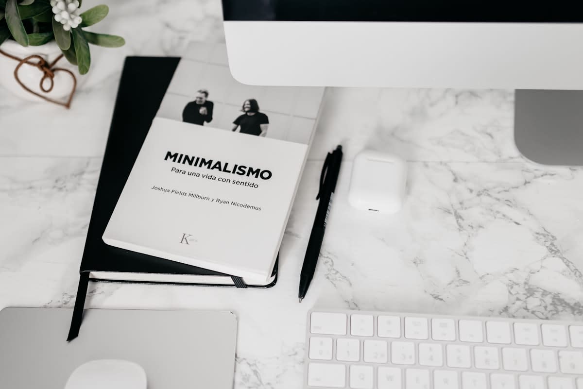 minimalist workspace with a physical notebook and a single book
