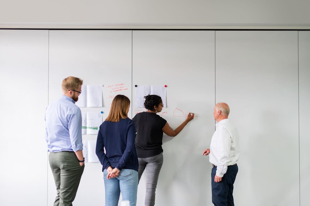 Diverse group of designers collaborating on a digital whiteboard
