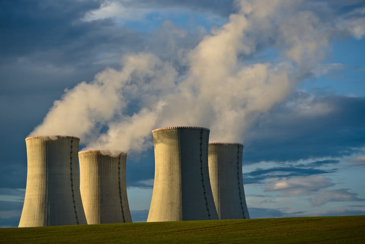 Geothermal power plant with steam rising from the ground