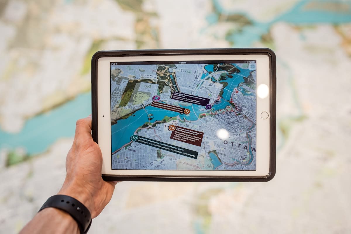 Digital tablet showing financial charts over a city map