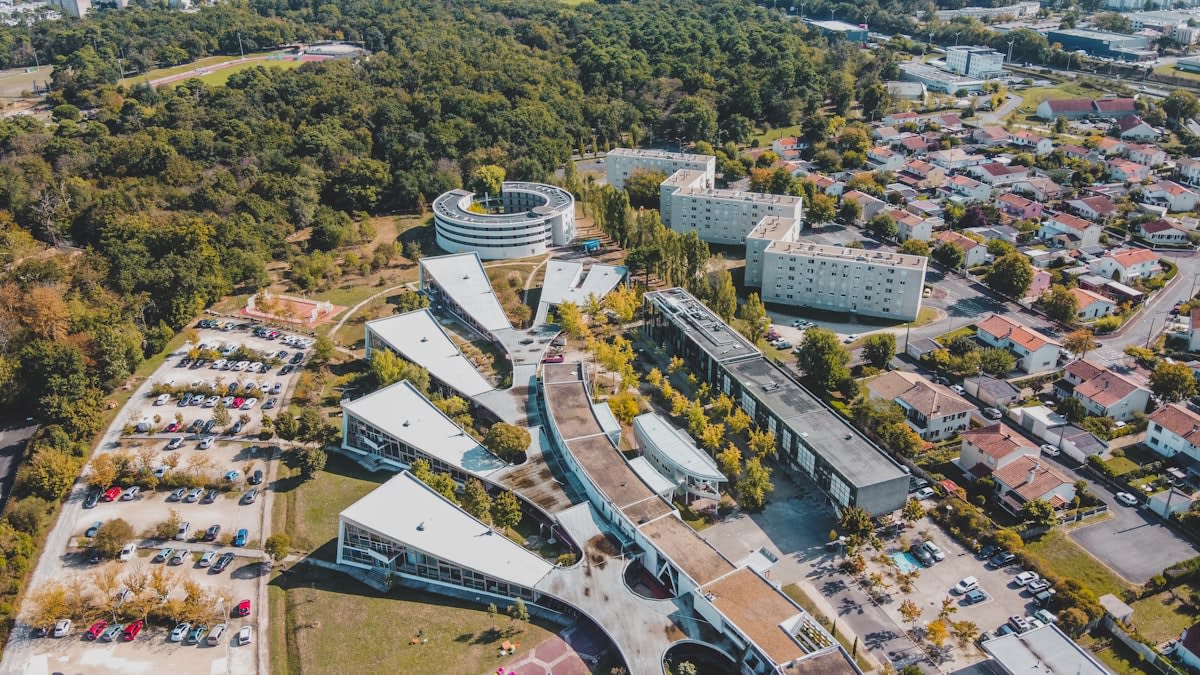 Aerial view of a small modern town with coworking spaces and green landscapes