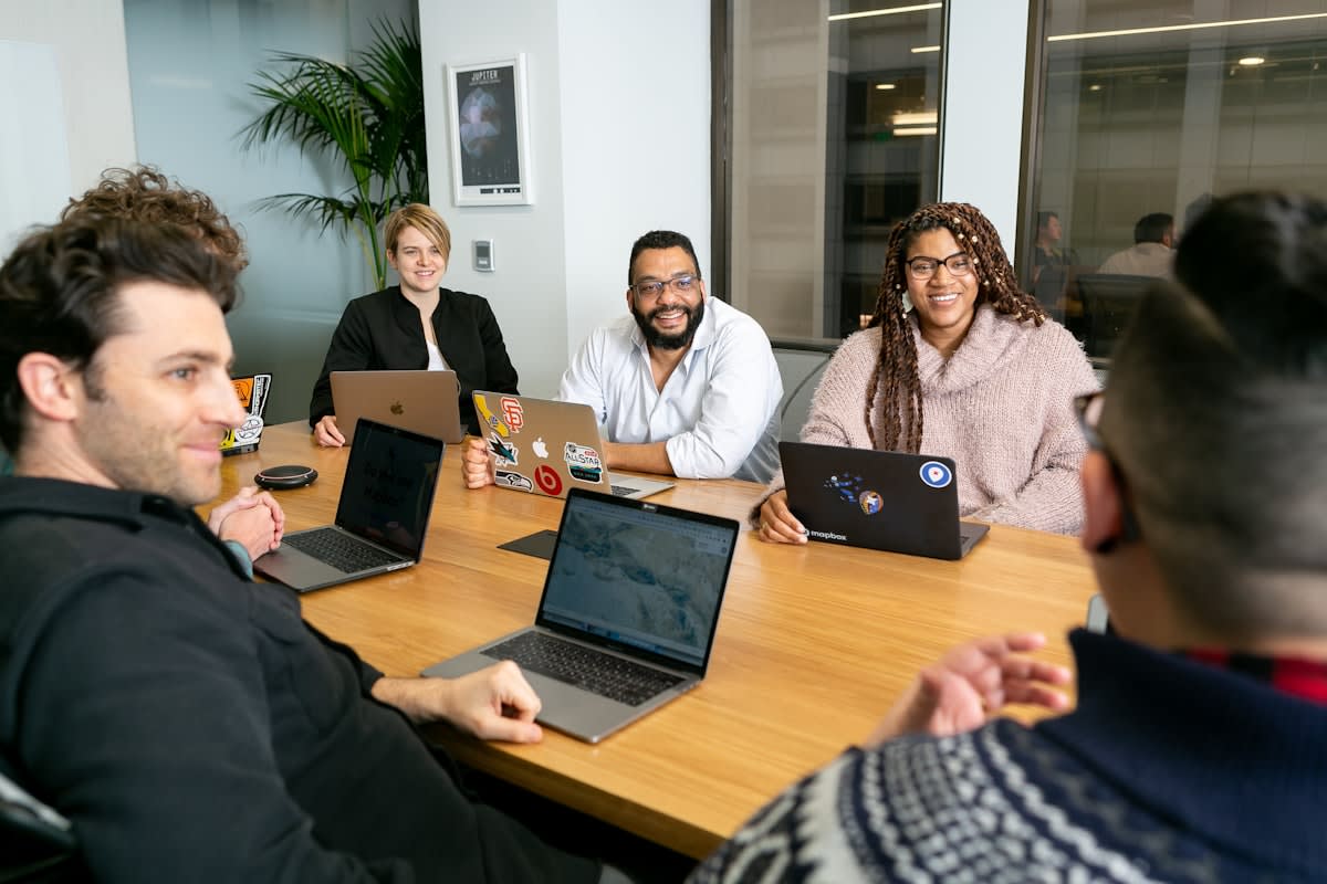 A diverse group of professionals in a collaborative, non-traditional workspace