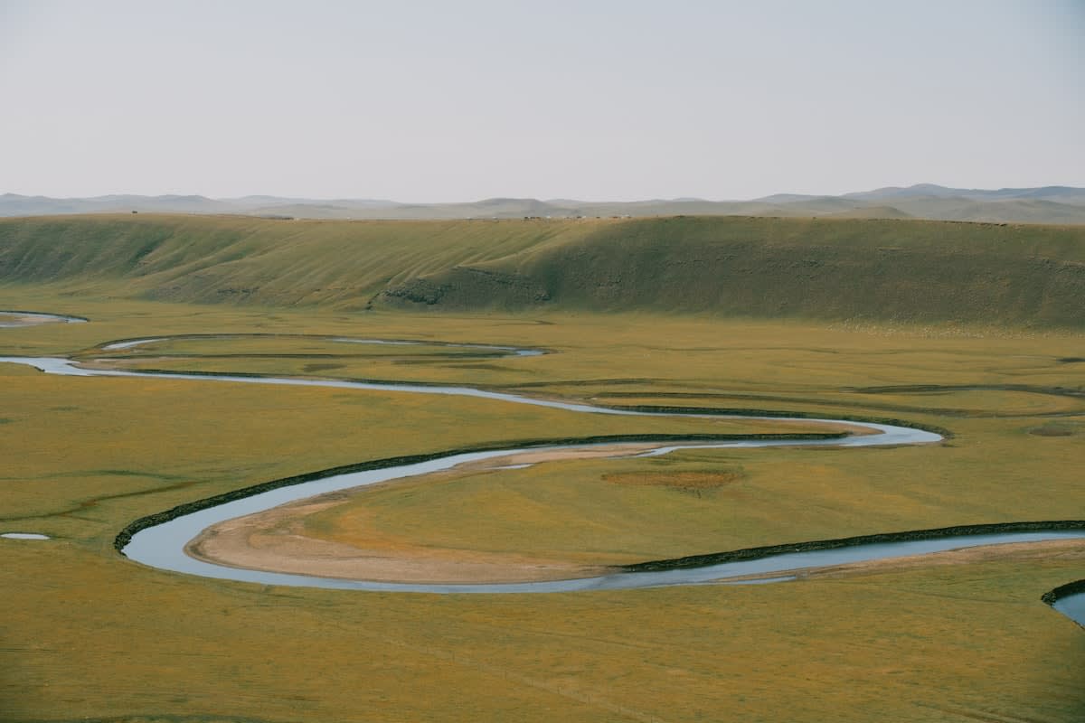Wide shot of a winding river through a valley