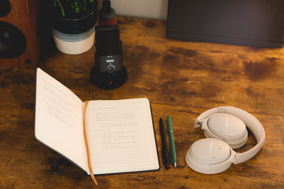 Close up of noise canceling headphones on a wooden desk