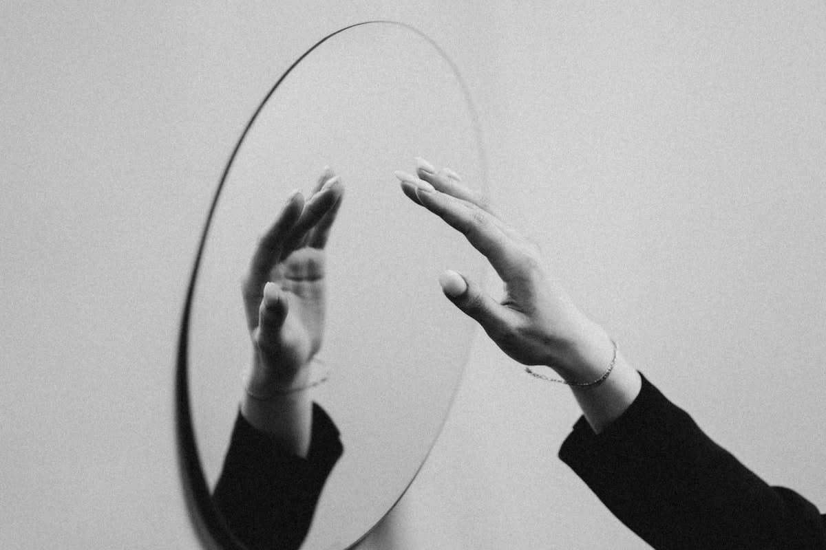 Person looking at a mirror that shows a different, more complex version of themselves