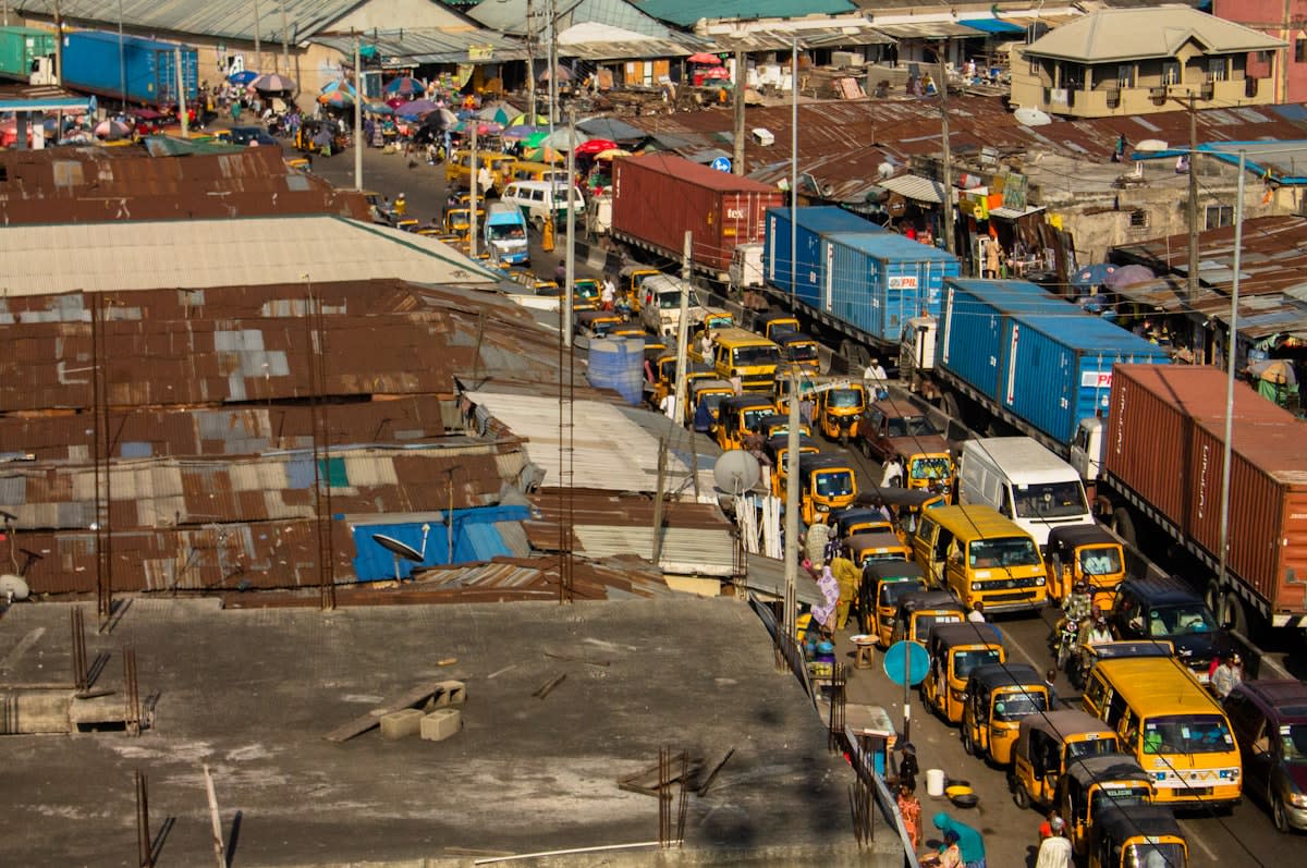 Busy marketplace in Lagos Nigeria with people using smartphones