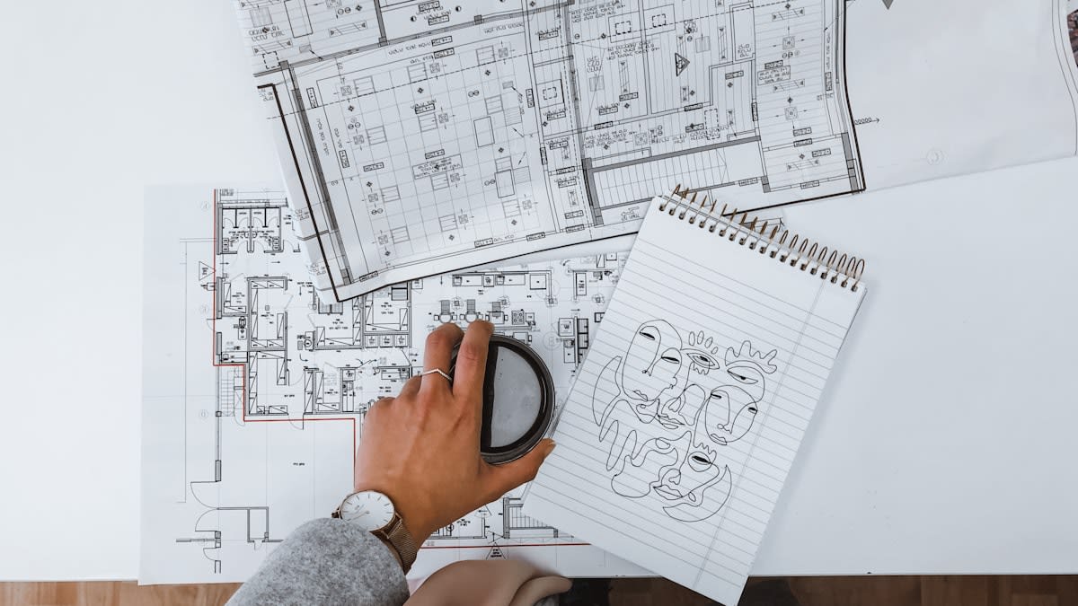 Detailed architectural blueprint and a magnifying glass
