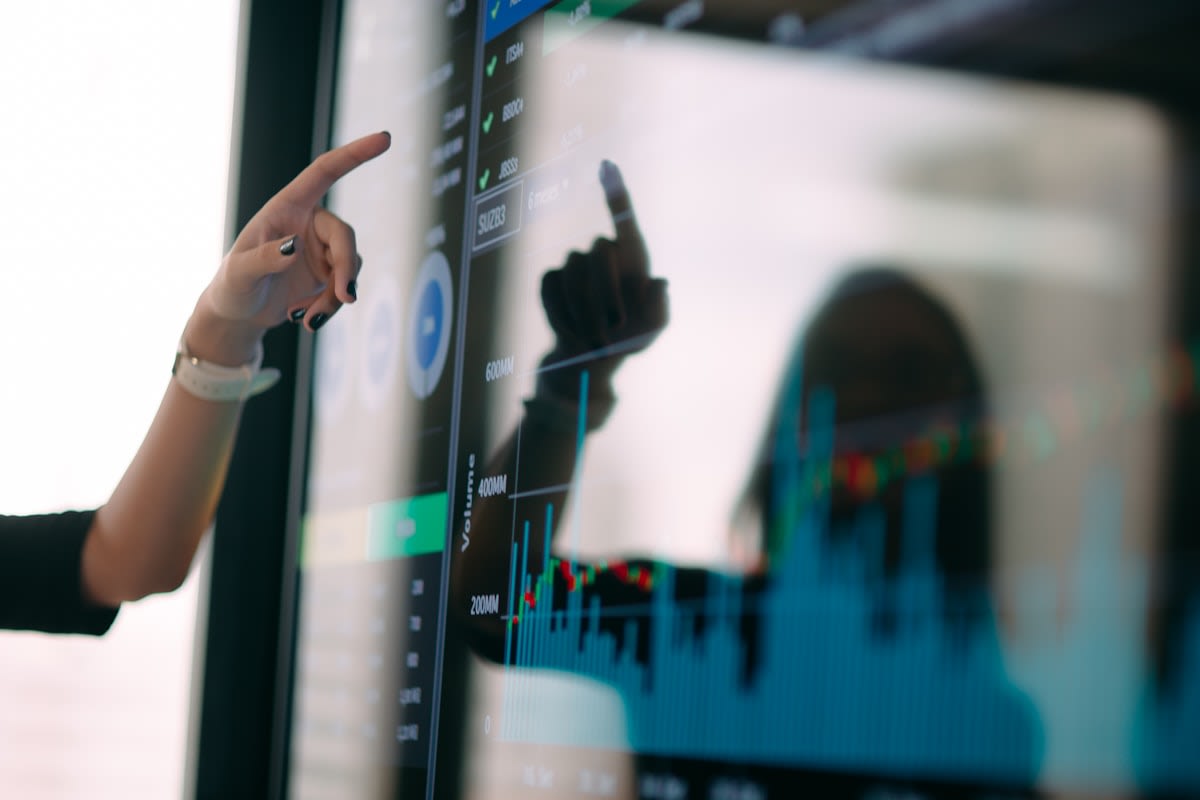 Data visualization on a screen with a person pointing