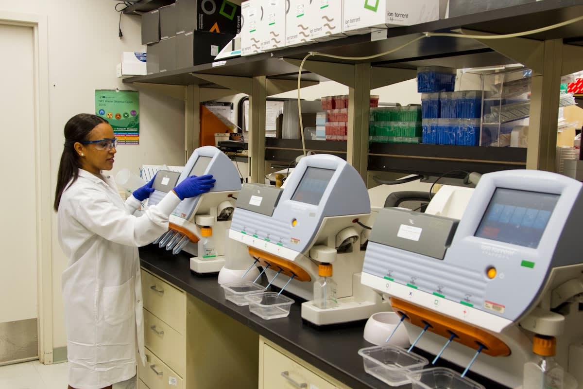 Laboratory technician analyzing genomic sequences on a screen