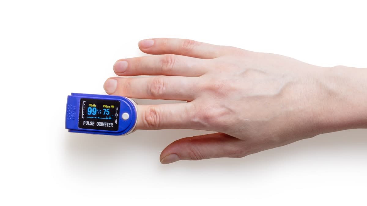 close up of a pulse oximeter showing oxygen saturation