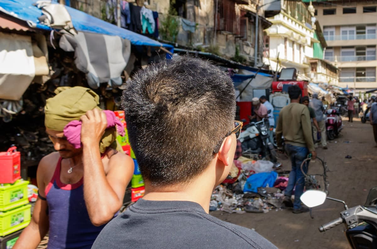 Smartphone displaying financial app in a busy market