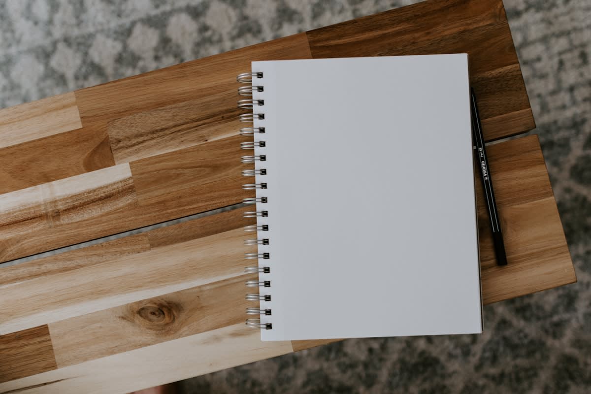 Clear desk with a single notebook