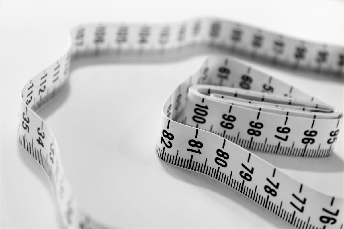 high end tailor measuring fabric