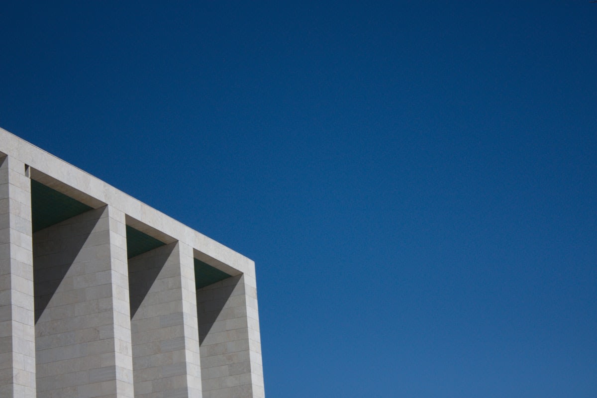 Minimalist concrete architecture with a single window and soft light