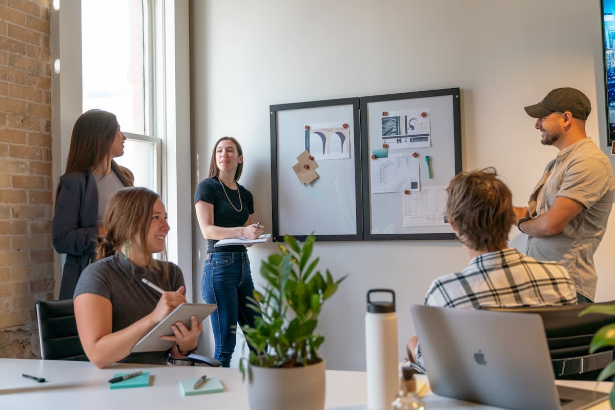 Strategic planning team in a modern office brainstorming on a whiteboard