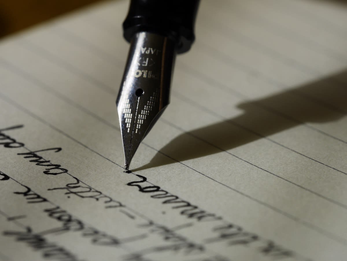 Close up of a fountain pen on thick textured paper