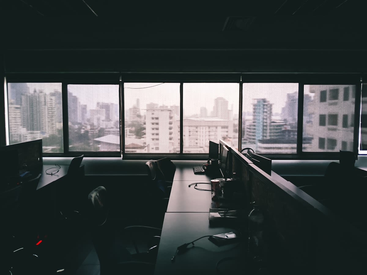 Minimalist dark office with a single light source