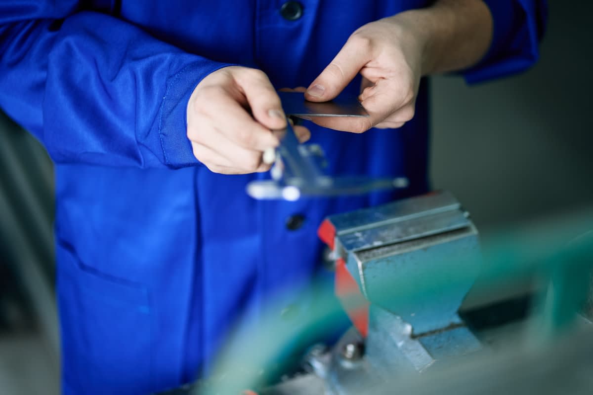 Close up of industrial machinist working with precision tools