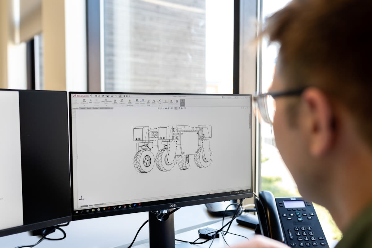 Blueprints and digital screens in an engineering office