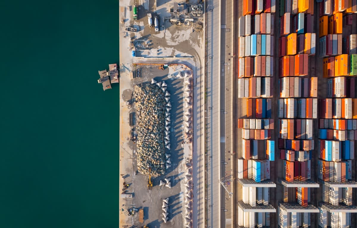 Aerial view of a massive container terminal with cranes