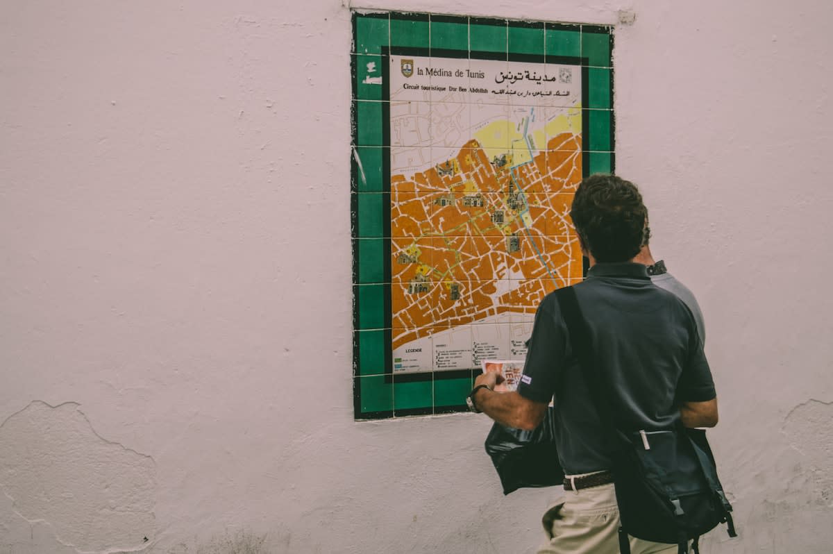 person looking at a complex city map