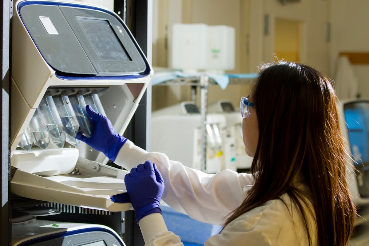 Laboratory technician analyzing genomic data on a screen