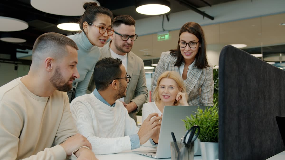 Diverse group of adults of different ages collaborating in a modern workspace