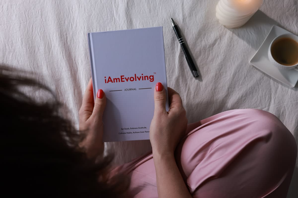 Person writing in a notebook in a minimalist setting