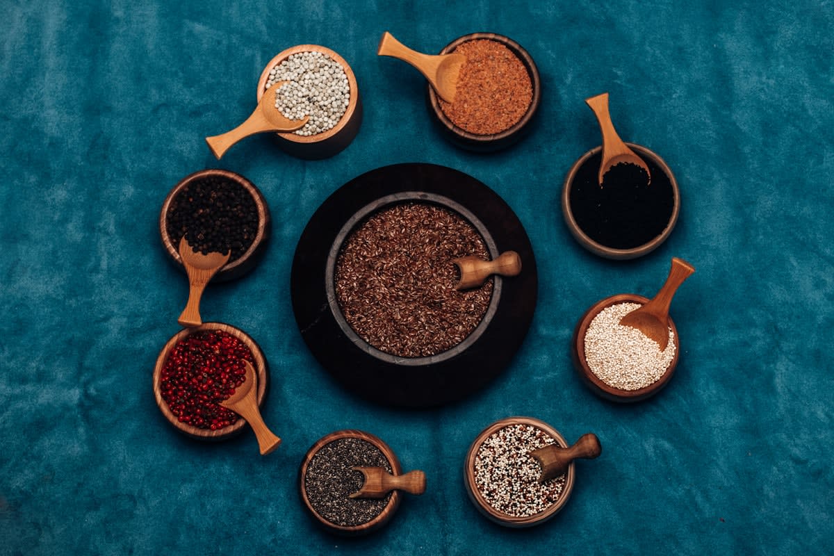 diverse ancient grains and seeds in wooden bowls