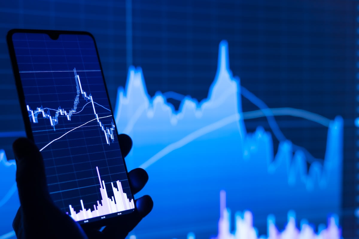 Smartphone with financial app in a busy market