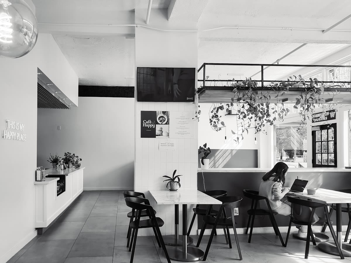 Modern minimalist urban cafe with people on laptops