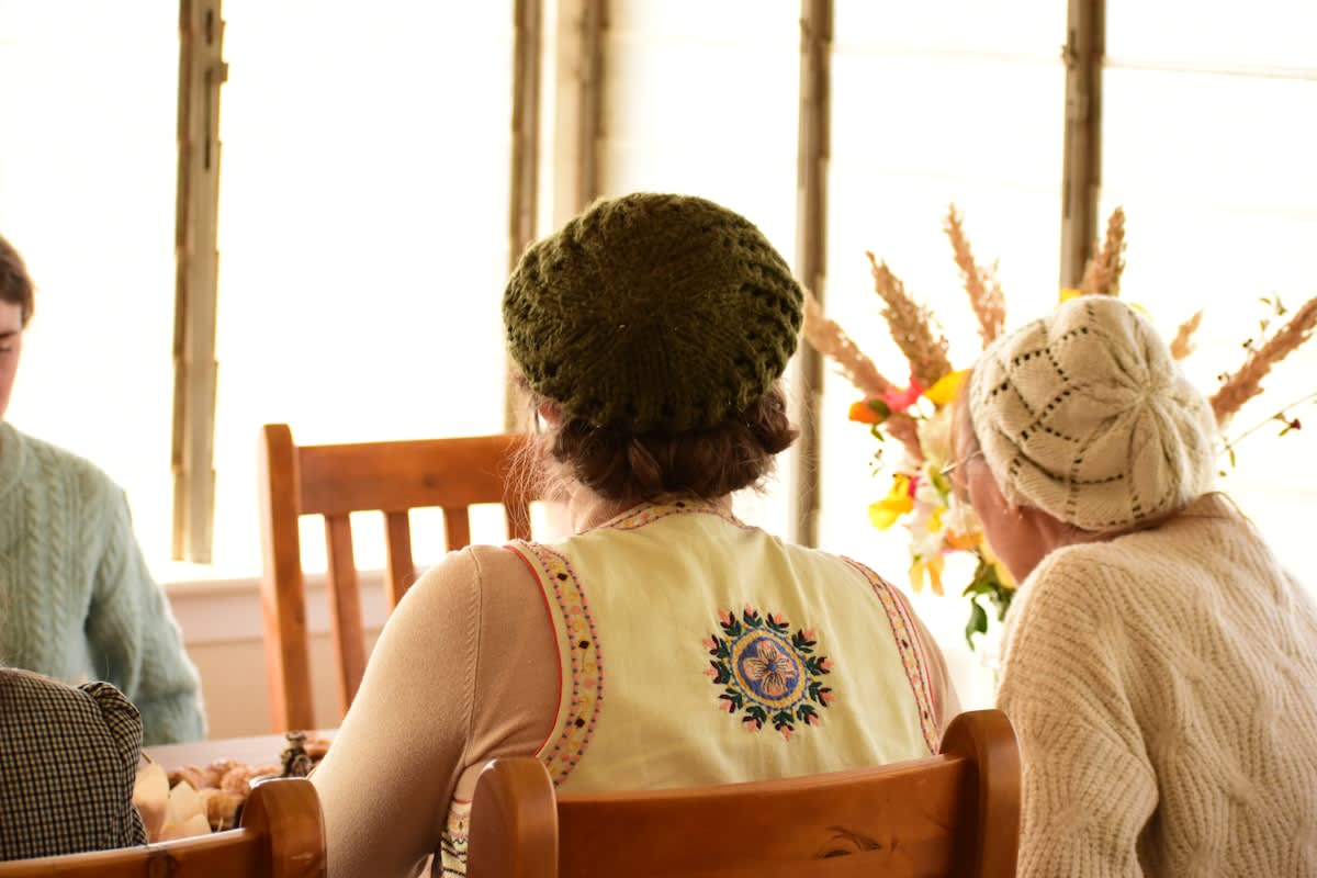 A small group of people engaged in a deep conversation in a cozy setting
