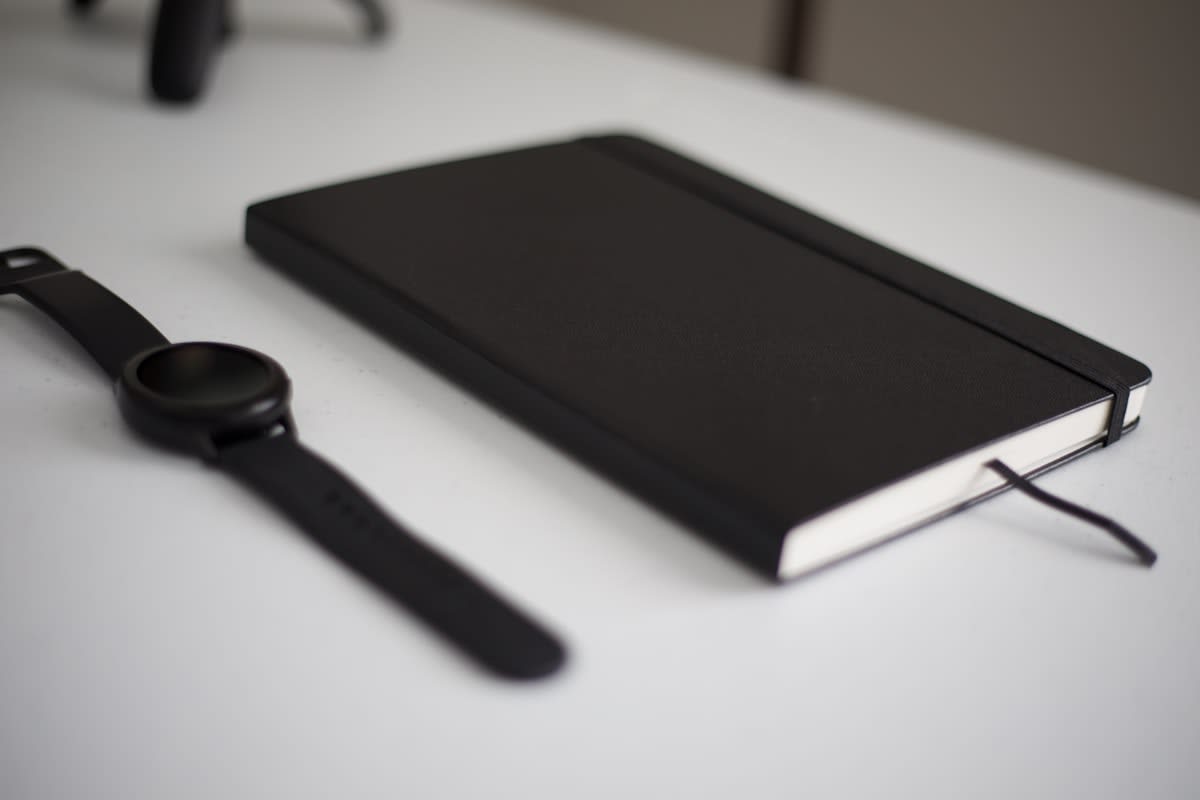 minimalist workspace with notebook and analog clock